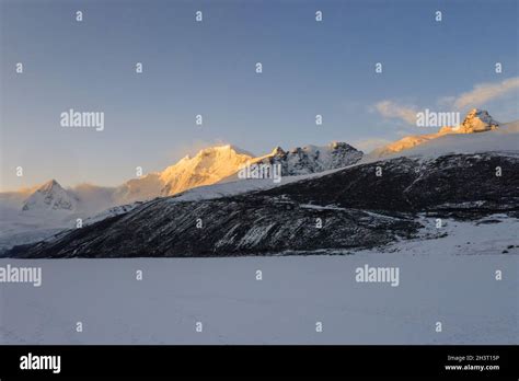 Snow mountain sunrise landscape Stock Photo - Alamy