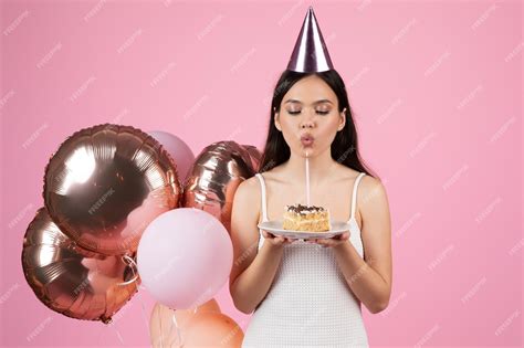 Premium Photo Lady Blowing Out A Candle On A Birthday Cake