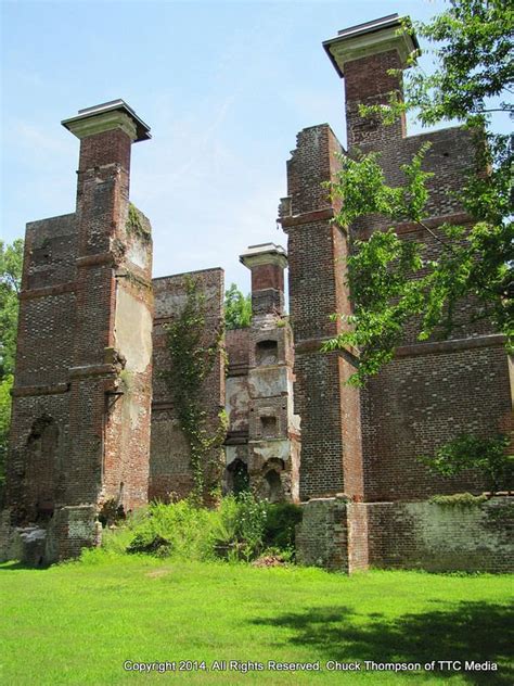 An Old Brick Structure In The Middle Of A Field