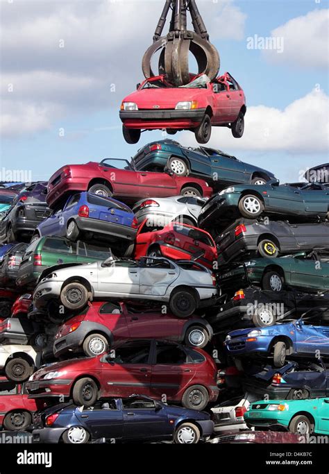 Another Car Is Added To Piles Of Scrapped Cars At A Car Recycling Plant