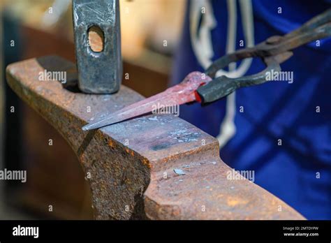 Blacksmith With Red Hot Iron At Work Stock Photo Alamy