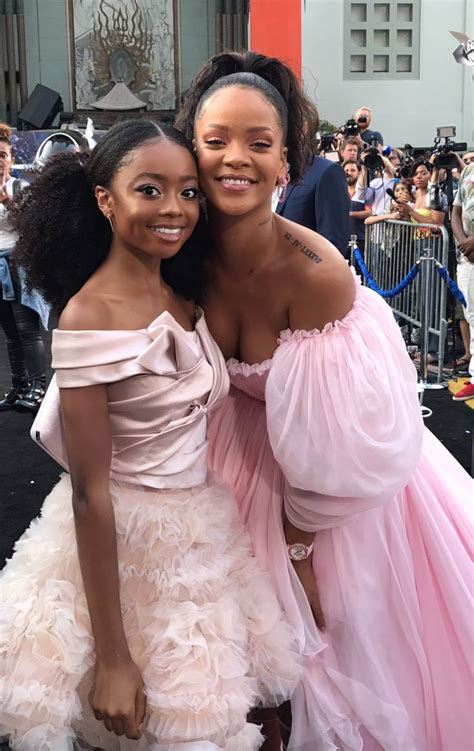 Two Women In Pink Dresses Posing For The Camera With Their Arms Around