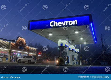 Illuminated Blue Awning With Chevron Gas Company Text Ar Night