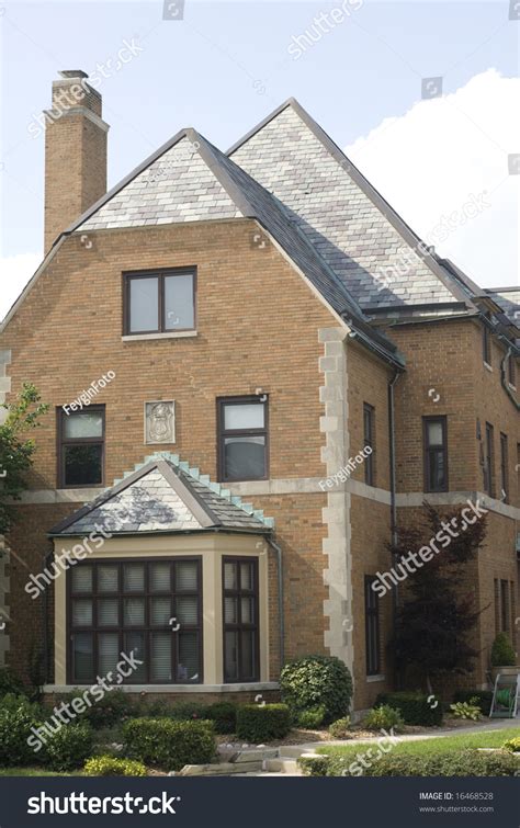 Big Bay Window On A Beautiful Brick House With A Steep Sloping Roof