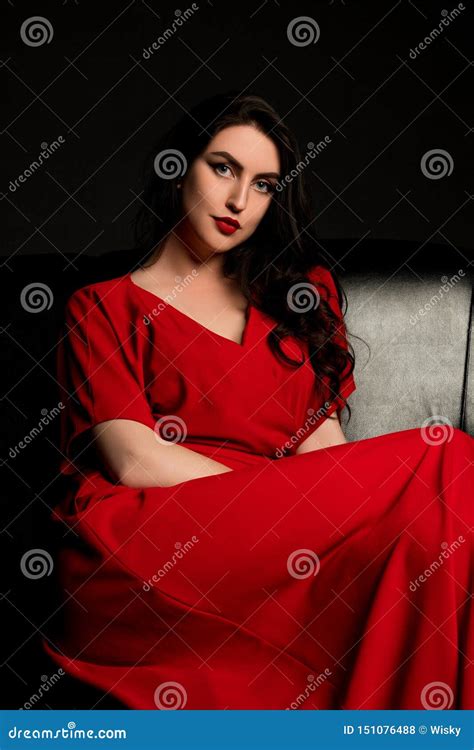Brunette In Red Sitting On The Sofa Stock Photo Image Of Silver Erotica