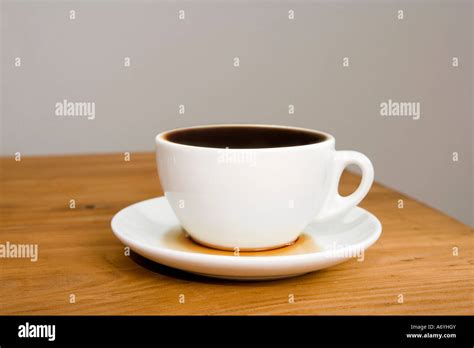 An Overflowing Coffee Cup Stock Photo Alamy