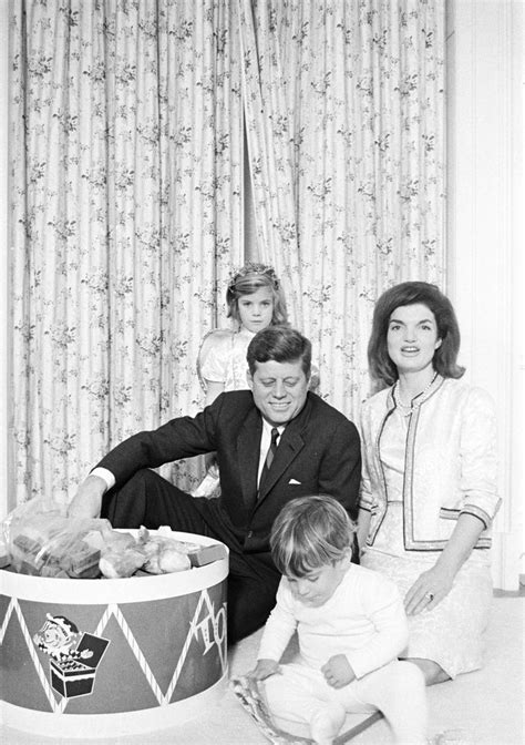 an old black and white photo shows a family with two children in front ...