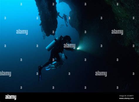 Scuba Divers Explore The Stalactites Inside The Great Blue Hole A