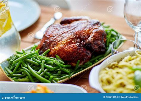 Roast Chicken With Garnish Of Green Peas On Table Stock Photo Image