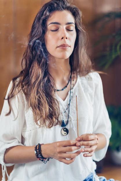 Premium Photo Young Woman Holding Burning Incense