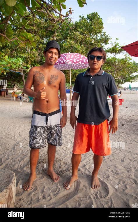 Two Balinese Men At The Beach In Kuta Bali One Shirtless With Tattoos