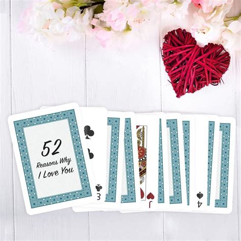 Four Playing Cards With The Number 52 On Them Next To Some Flowers And