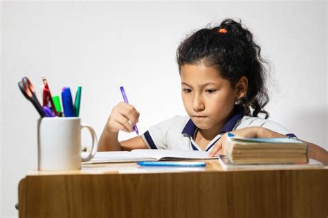 Premium Photo Latina Brunette Girl Studying At Her Desk With An Amazed Face While Doing Her