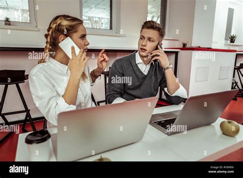 Long Haired Blonde Woman Asking Her Workmate About Working Aspect Stock Photo Alamy