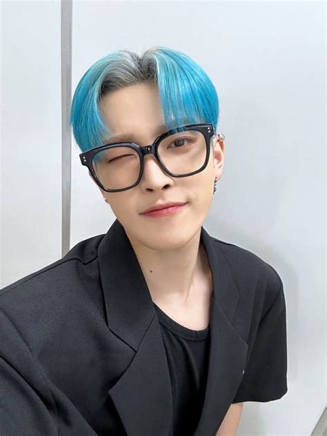 A Person With Blue Hair And Glasses On