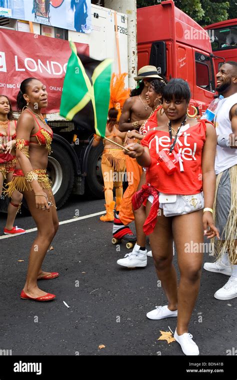 Girls dancing at the Notting Hill Carnival waving Jamaican flag Stock ...