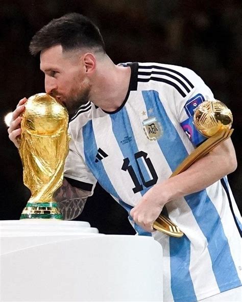 A Soccer Player Kissing The World Cup Trophy