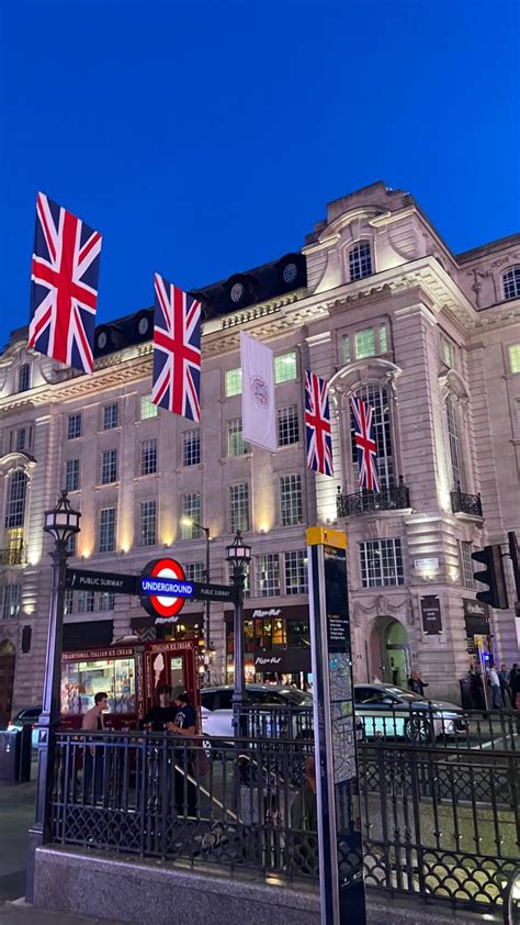 The British Flag Is Flying In Front Of A Large White Building With