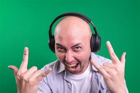 Premium Photo Asian Bald Man Listening Music With Headphones While