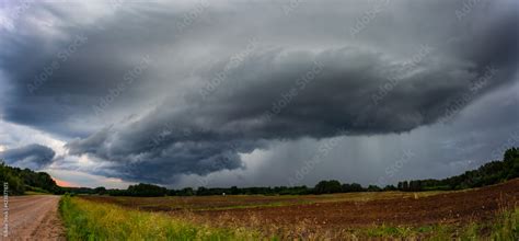 Supercell storm clouds with wall cloud and intense rain Stock Photo | Adobe Stock