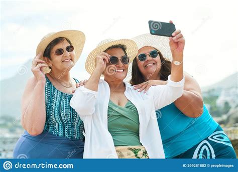 Theyll Never Be Able To Guess Our Age A Mature Group Of Friends Standing Together And Using A