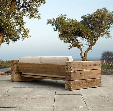 A Couch Made Out Of Wooden Planks Sitting On Top Of A Stone Floor Next