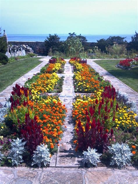 A Garden With Many Different Types Of Flowers And Plants In The Center