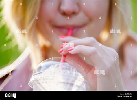 Blonde Drinks Cocktail From Tube Stock Photo Alamy