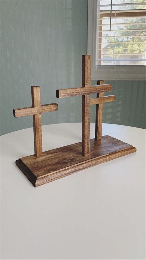 Two Wooden Crosses Sitting On Top Of A Table