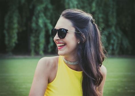 Premium Photo Smiling Woman Wearing Sunglasses Against Trees