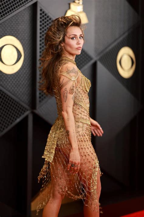 Miley Cyrus Wore A Completely Sheer Gold Netted Dress To The 2024 Grammys