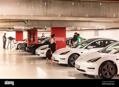 New Owners Collect Their Tesla Model 3 Electric Vehicle From Tesla In