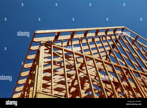 Close Up Of Gables Roof On Stick Built Home Under Construction And Blue