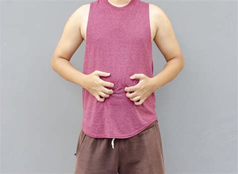 Asian Man Scratching Itch With Hand On Belly Area Health Care Concept