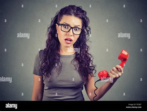 Resentful Shocked Young Woman Looking In Disbelief Holding Telephone