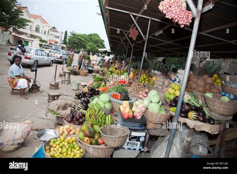 Women Sell Fruits And Vegetables At The Les Cocotier Market In