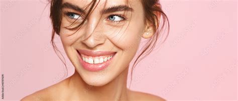 Close Up Of Fresh Natural Woman With Nude Makeup White Smile Looking Aside On Pink Background