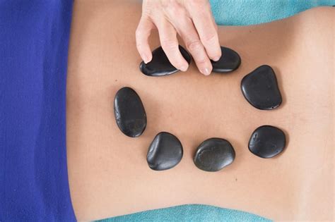 Premium Photo Adult Woman Having Hot Stone Massage In Spa Salon Beauty Treatment Concept