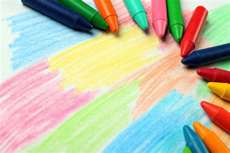 Oil Pastel Crayons Lying On A Paper With Painted Rainbow Stock Photo