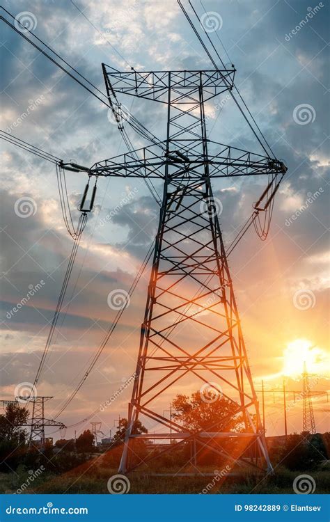 High Voltage Power Transmission Towers In Sunset Sky Background Stock