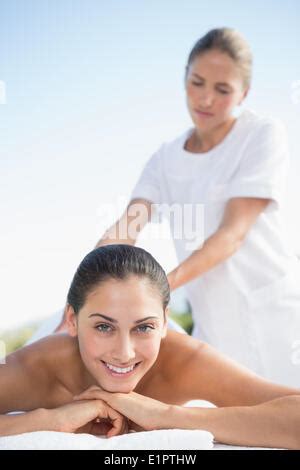 Happy Brunette Enjoying A Massage Poolside Stock Photo Alamy