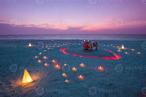 Beautiful table set up for a romantic meal on the beach with lanterns ...