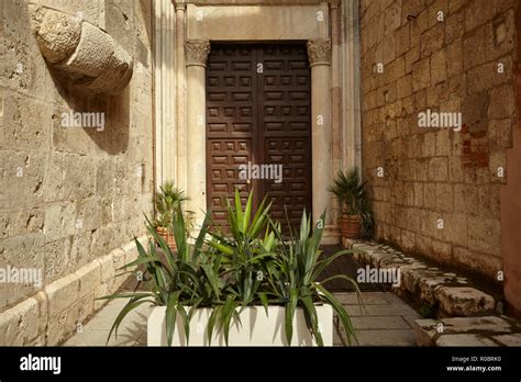 Architectural Detail Of A Large Wooden Door Anchored To Two Marble