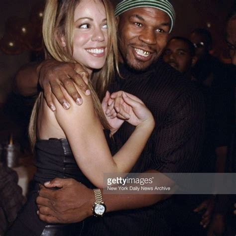 Mike Tyson And Mariah Carey Hugging During Opening Of Sean Puffy