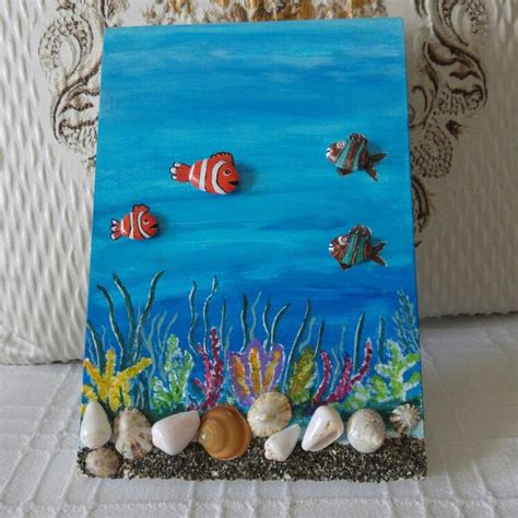 An Acrylic Painting Of Fish And Seashells On A Canvas