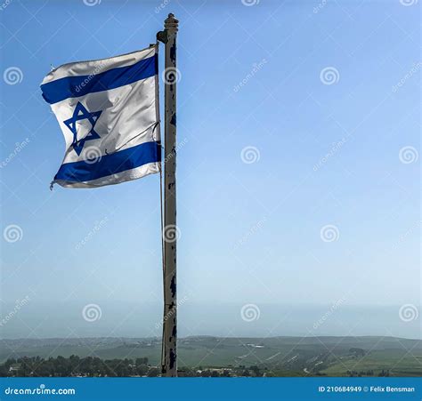 Partially Torn Israeli Flag is Waving in the Wind on Sky Background ...