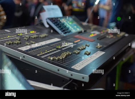 Soundman Working On The Mixing Console Hands On The Sliders Stock