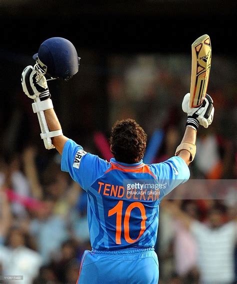 India Cricketer Sachin Tendulkar Raises His Bat To Celebrate Scoring A