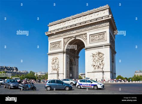 Busy Traffic Around The Roundabout At The Arc De Triomphe And The