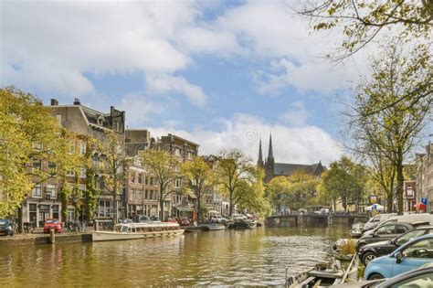 A Canal in Amsterdam with Boats and Buildings Editorial Photography ...